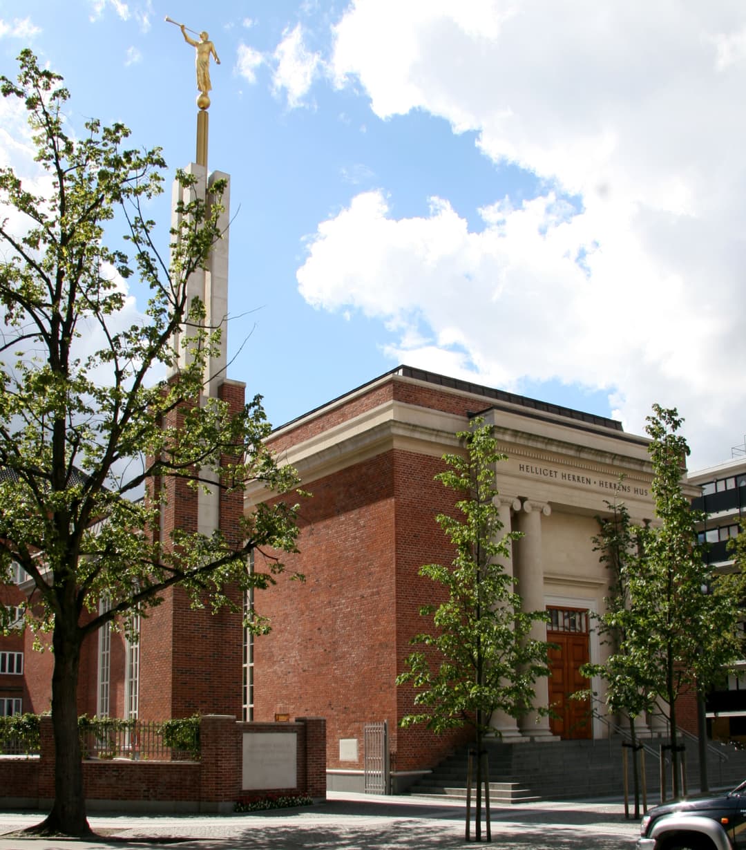 Daytime exterior view of the Copenhagen Denmark Temple facade and spire.