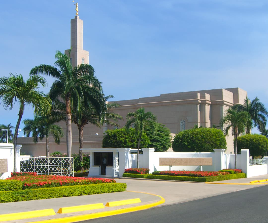 Front entrance and spire of the Santo Domingo Temple in daylight.