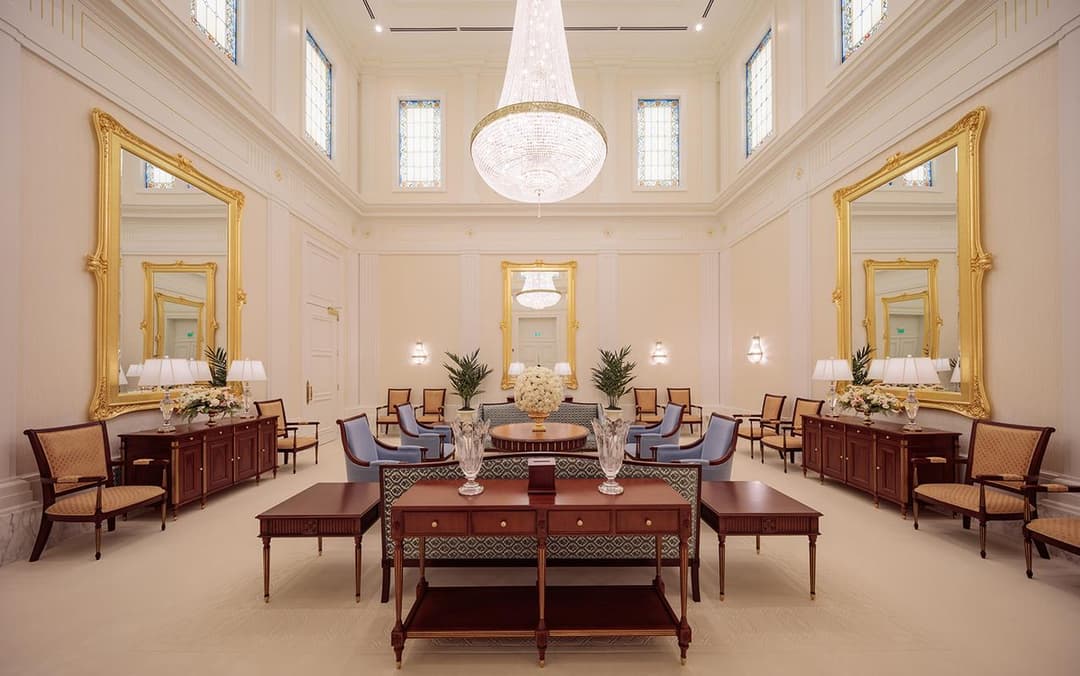 Interior view of a waiting area featuring a large crystal chandelier.