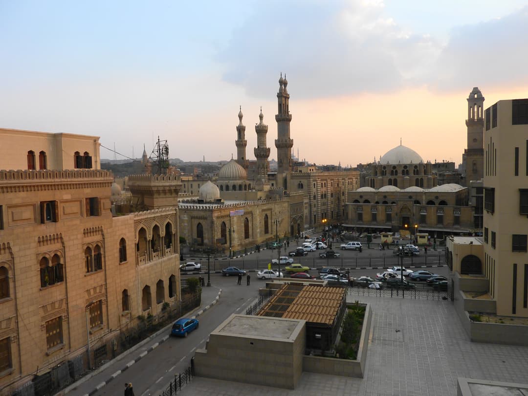 Elevated view of Al-Azhar Mosque minarets and domes at dusk