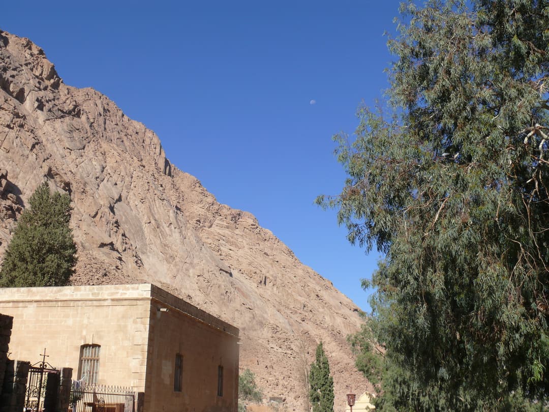 Monastery grounds and stone building beneath the rugged Sinai mountains