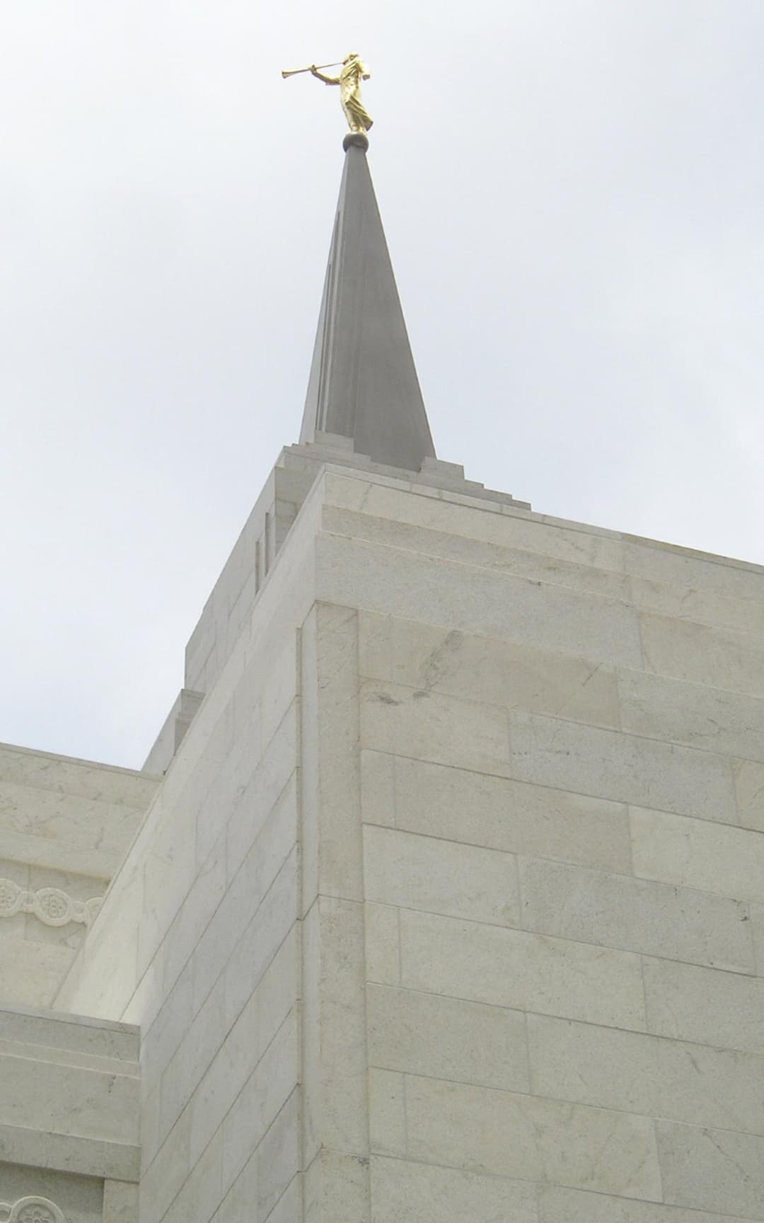 Low-angle view of the central spire and golden Angel Moroni statue.
