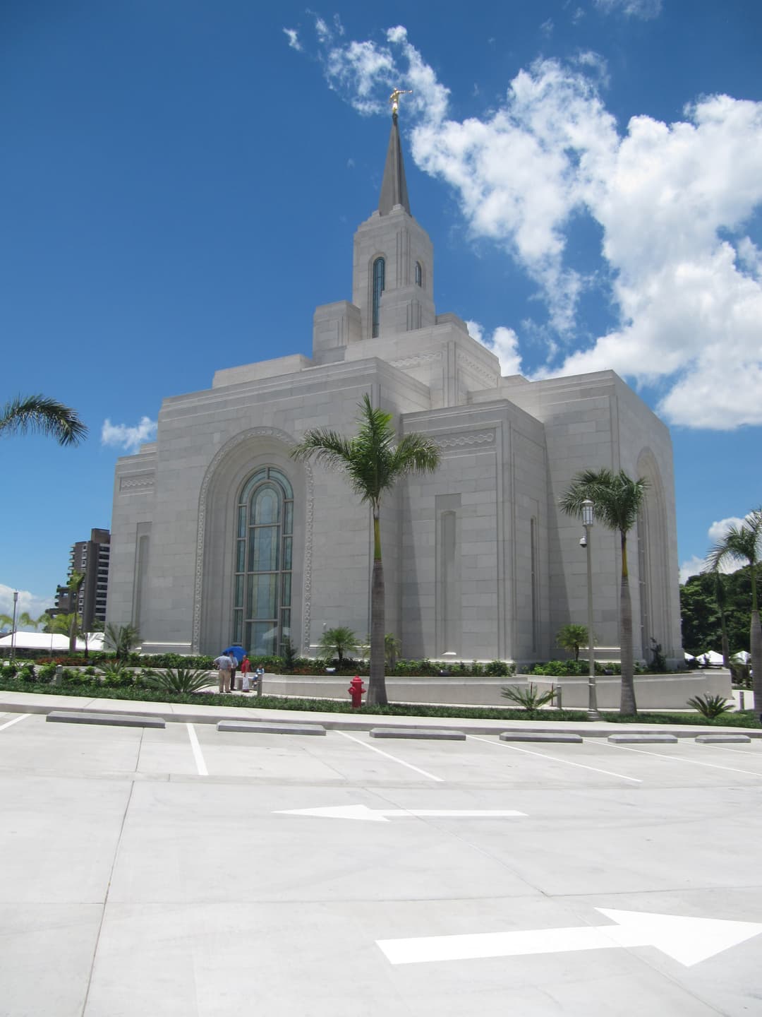 Daytime exterior view of the temple and central spire from the parking lot.
