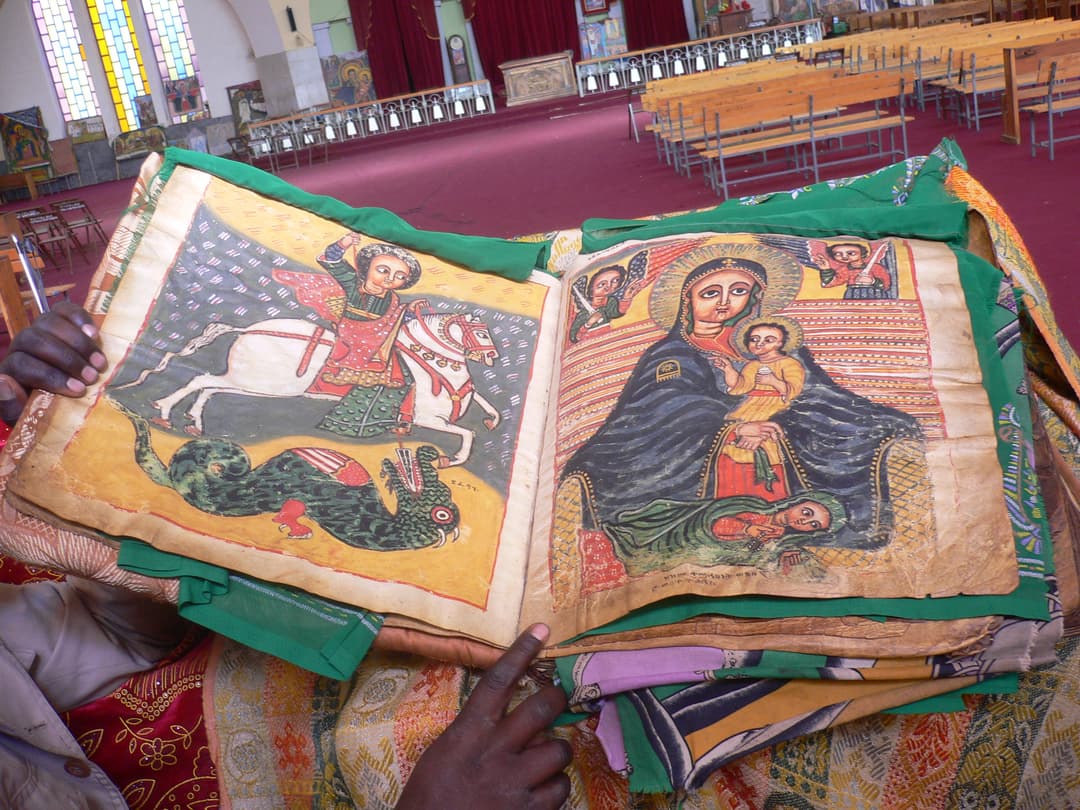 Illuminated manuscript showing St. George and the Virgin Mary in the church