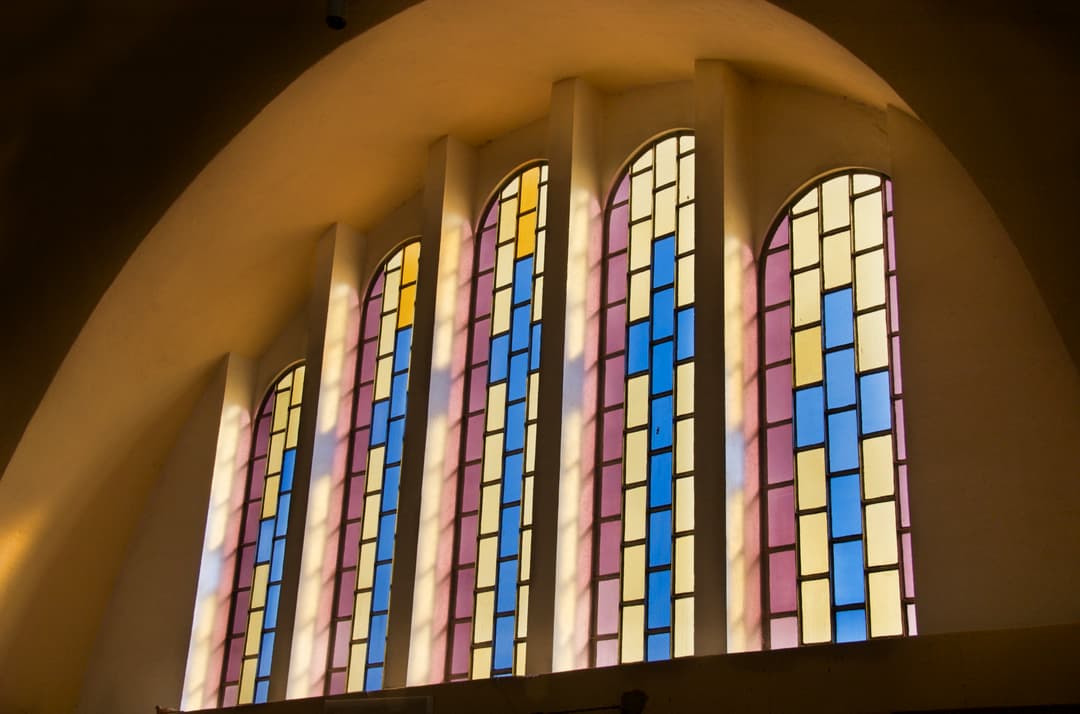 Arched stained-glass windows inside the New Cathedral of Mary of Zion