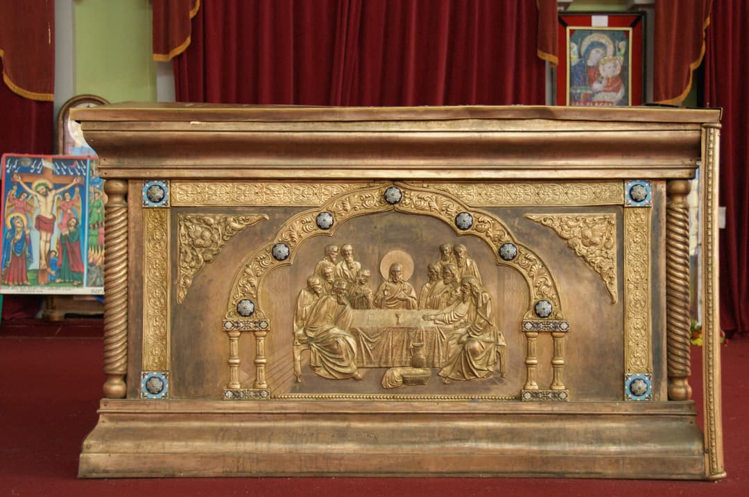 Altar featuring a Last Supper relief inside the church