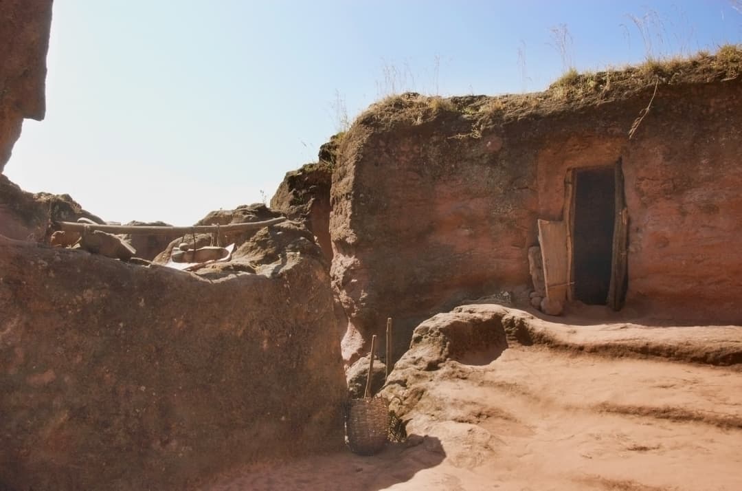 Rock-hewn hermit cell entrance and courtyard in Lalibela