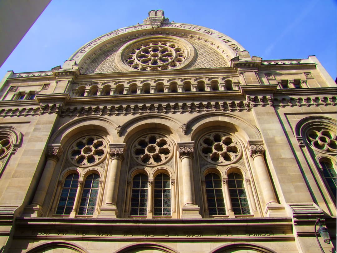 Low-angle view of the facade of the Grande Synagogue de Paris.