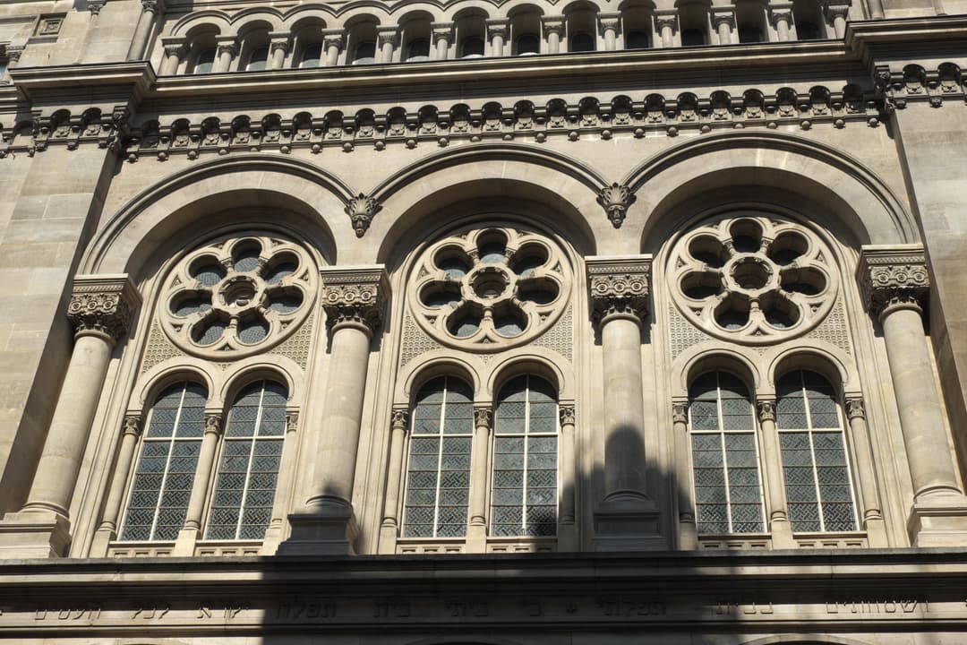 Low-angle daylight view of the upper facade and rosette windows.