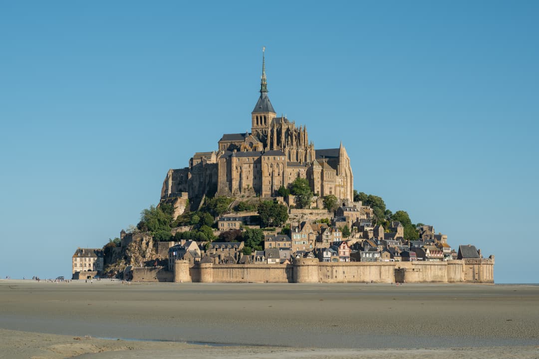 Wide view of Mont Saint-Michel across the tidal flats at low tide