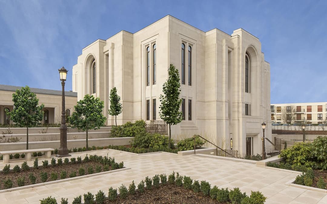 Paris Temple exterior, daytime view with formal gardens.
