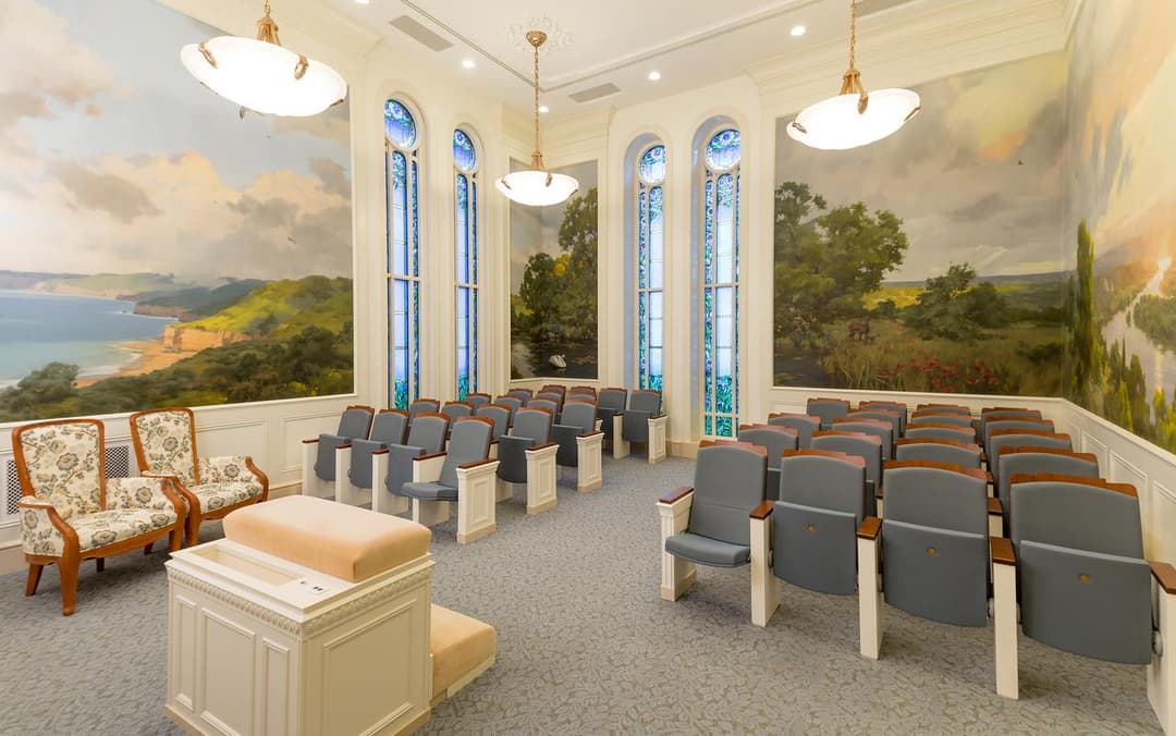 Paris Temple: Interior shot of a sealing room with wall murals and seating.
