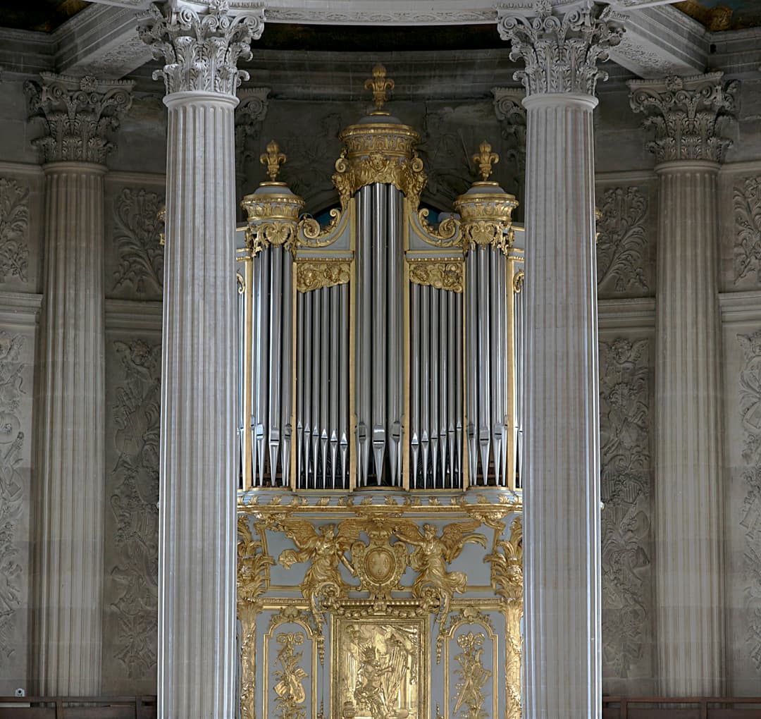 Gilded pipe organ framed by Corinthian columns, Royal Chapel of Versailles.