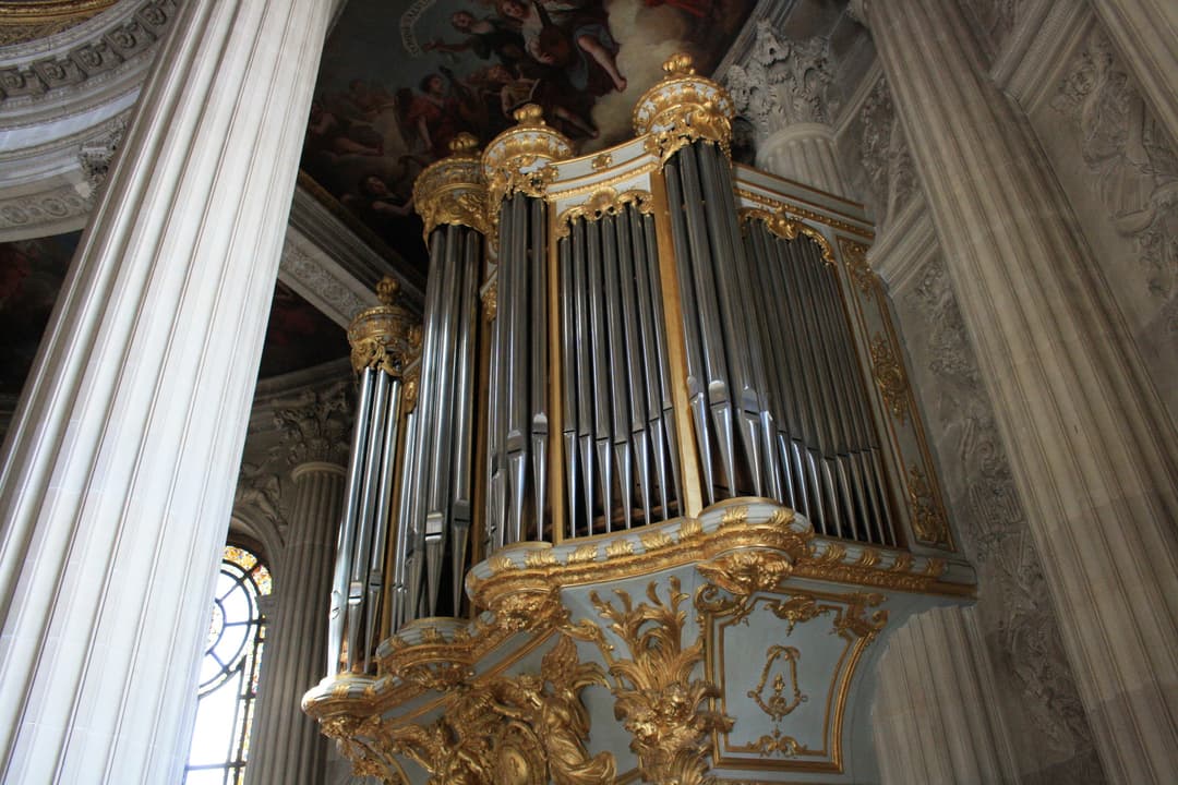 Ornate gilded pipe organ inside the Royal Chapel of Versailles.