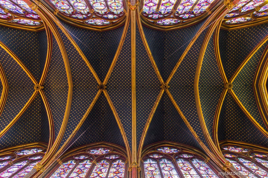 Starry blue vaulted ceiling and gold ribs inside Sainte-Chapelle.