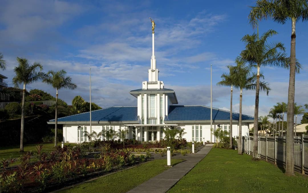Papeete Tahiti Temple: Front view with spire, angel Moroni, and blue tile roof.