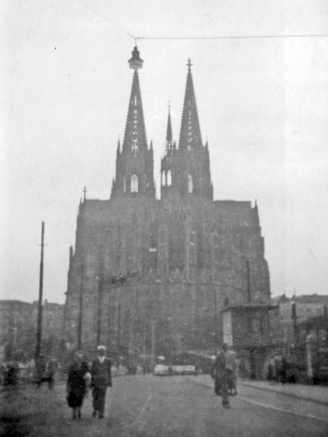 Historic street view of Cologne Cathedral and twin spires