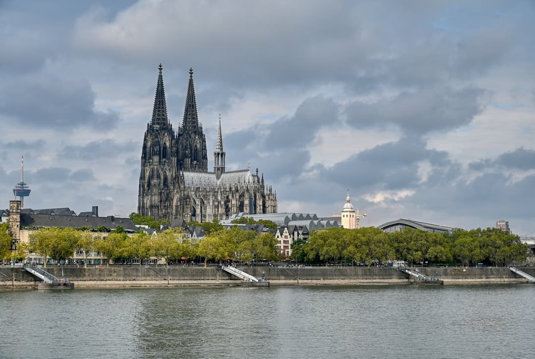 Cologne Cathedral and its twin spires viewed across the Rhine River.