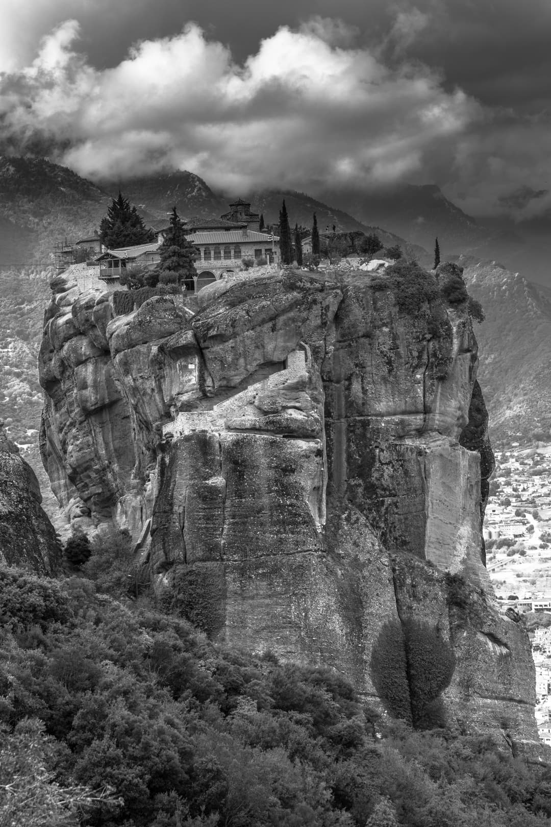 Monastery of the Holy Trinity atop a sheer rock pillar in black and white