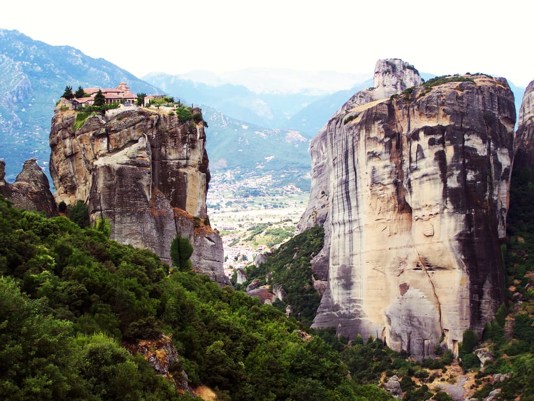 Wide-angle view of Holy Trinity Monastery atop a sheer rock pillar
