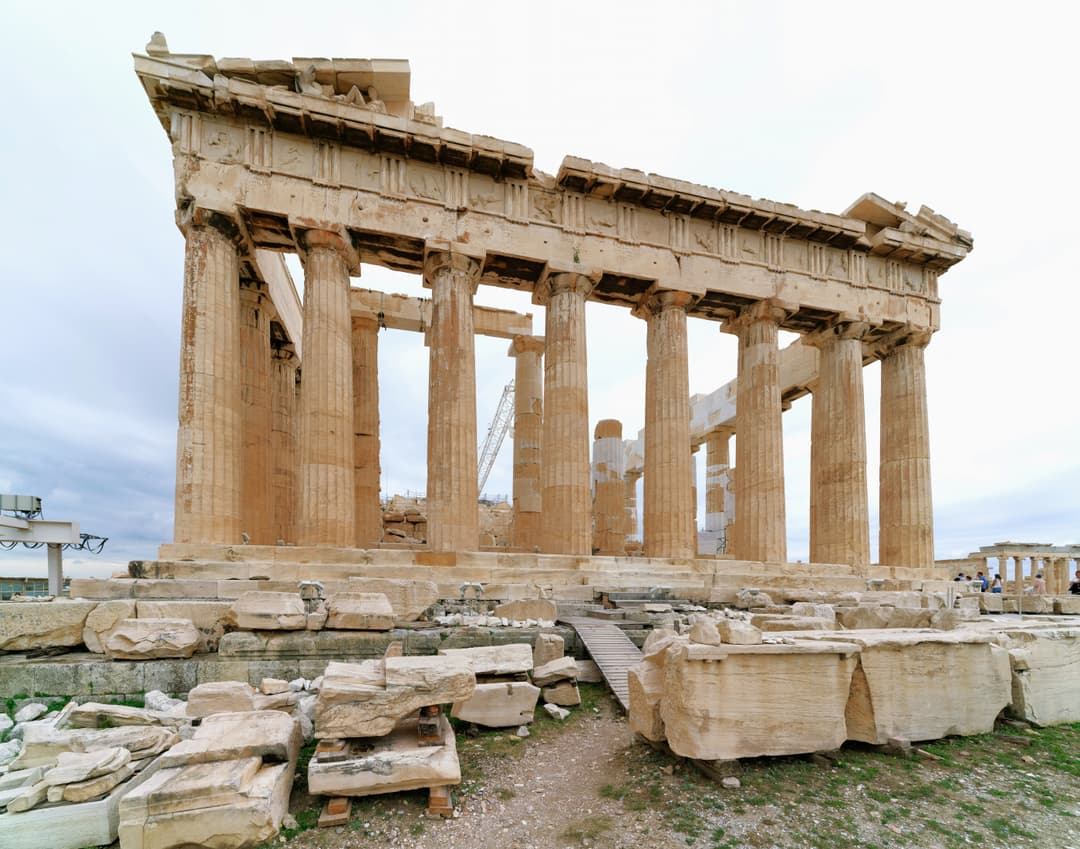 Wide-angle view of the Parthenon colonnade with foreground ruins