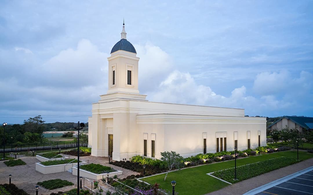 Exterior view of the Yigo Guam Temple and grounds at twilight.