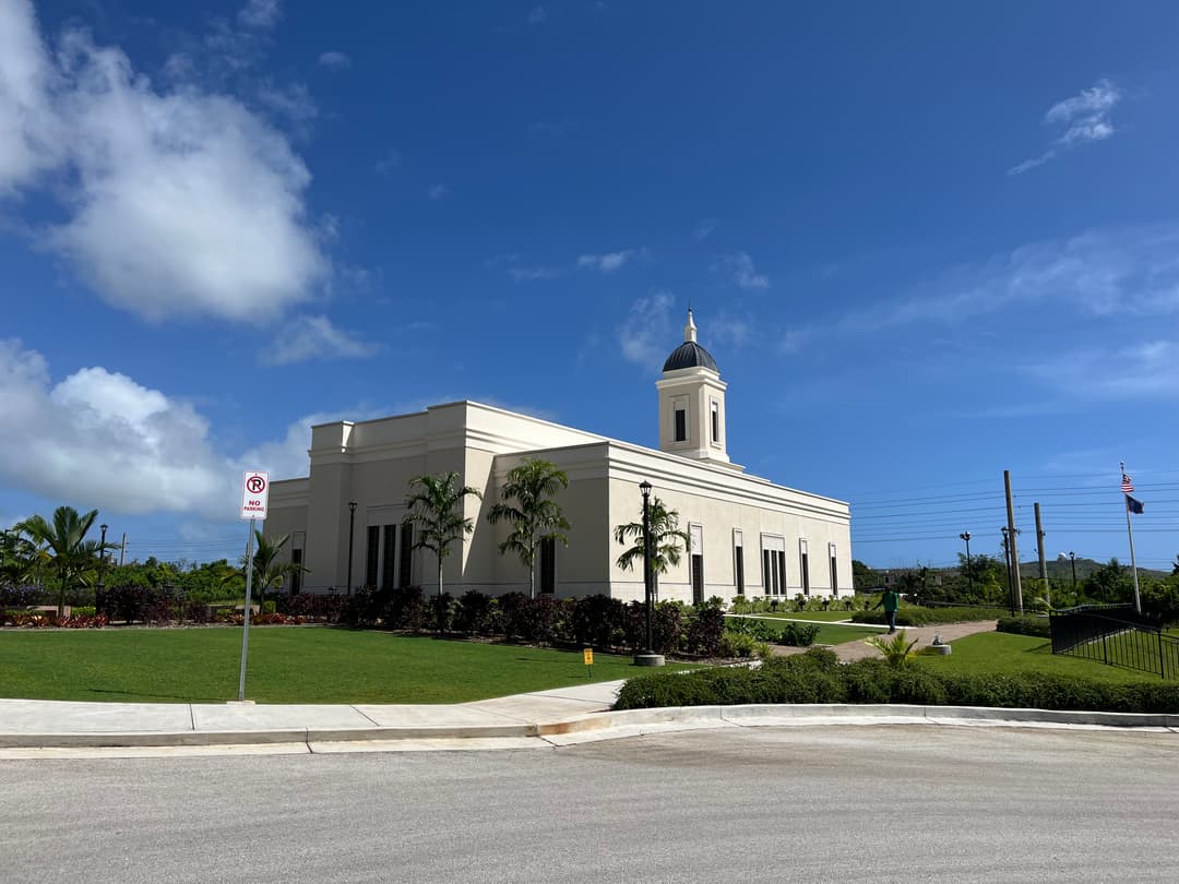 Daytime exterior view of the Yigo Guam Temple and landscaped grounds.