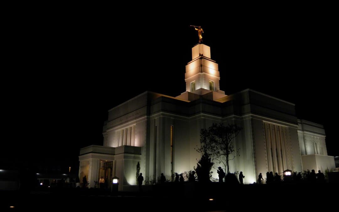 Illuminated exterior of the Quetzaltenango Guatemala Temple at night.
