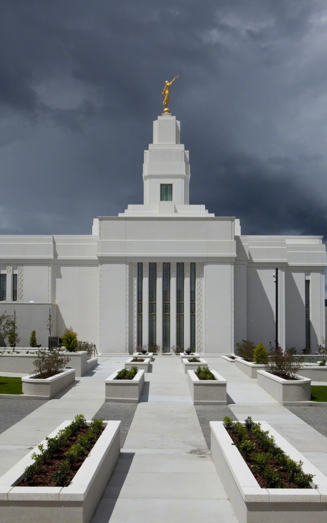 Front view of the Quetzaltenango Guatemala Temple under a stormy sky.