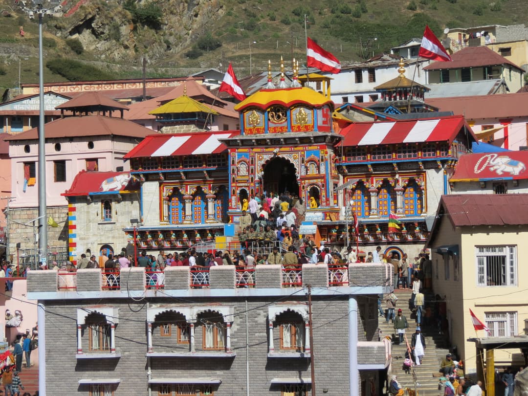 Front entrance and colorful facade of Badrinath Temple with pilgrims
