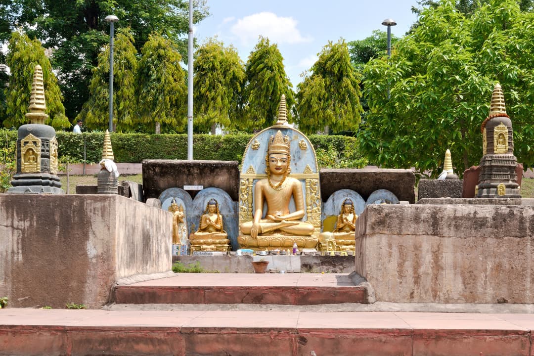 Grounds view of Buddha statues and stupas.