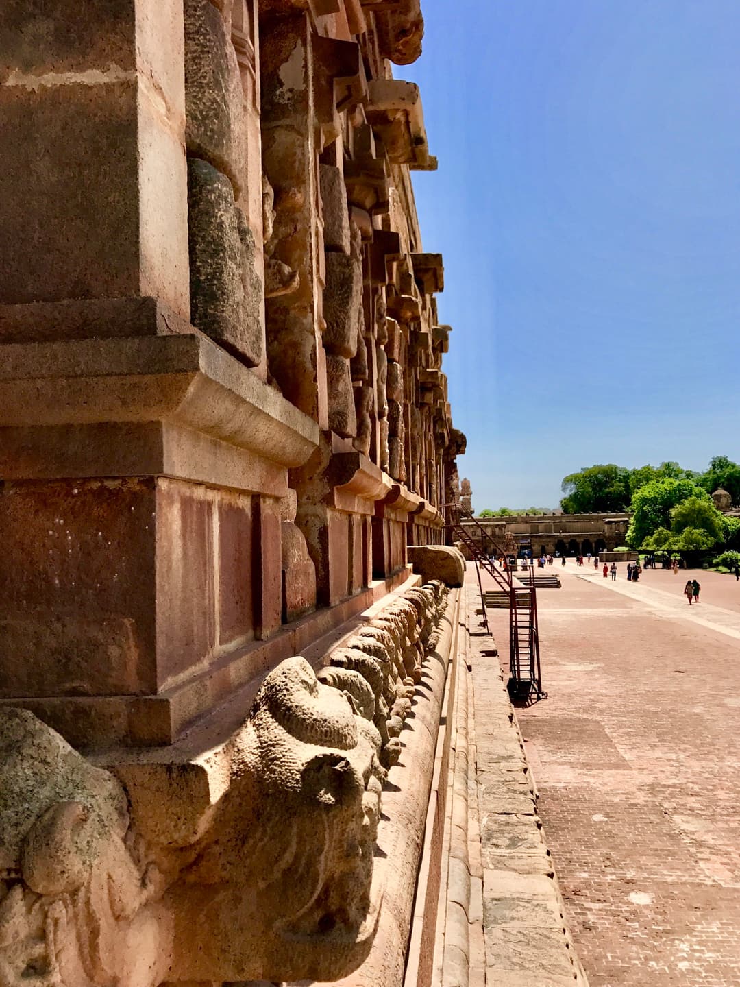Carved granite base and exterior wall overlooking the sunlit courtyard.