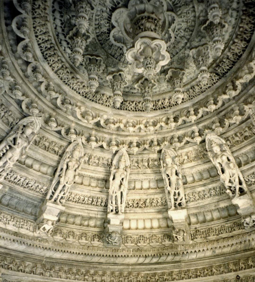 Interior view of an intricately carved corbelled marble dome ceiling