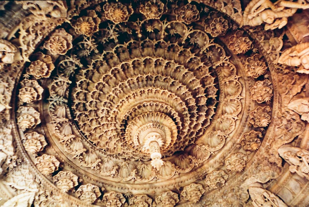 Intricately carved marble ceiling dome with central pendant