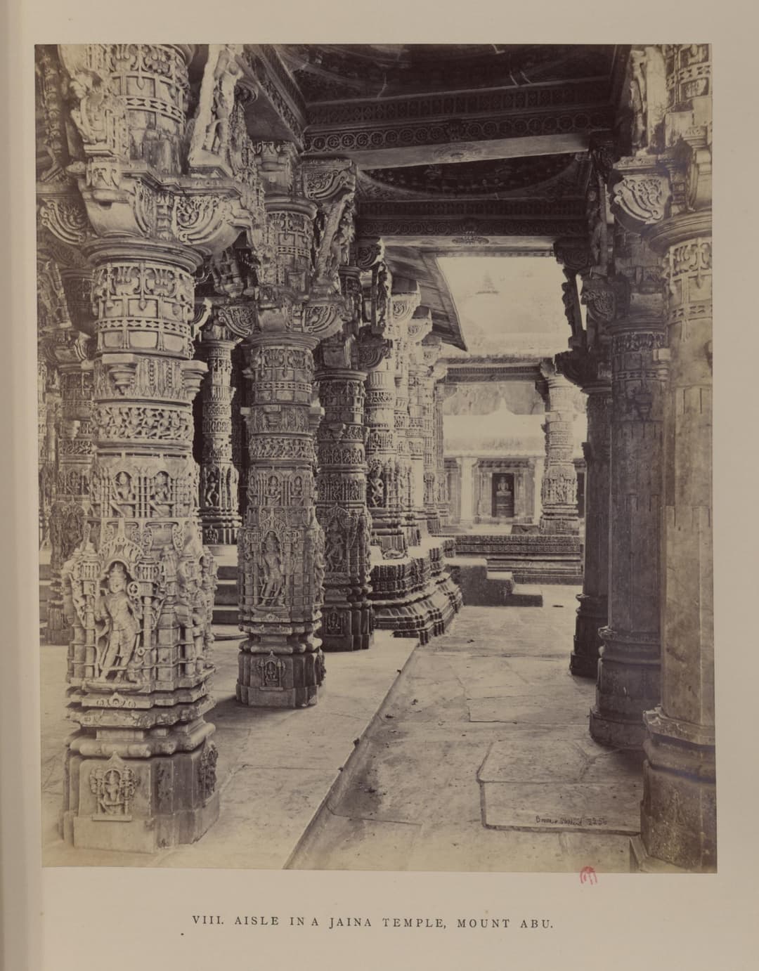 Intricately carved marble pillars along an aisle at Dilwara Temples