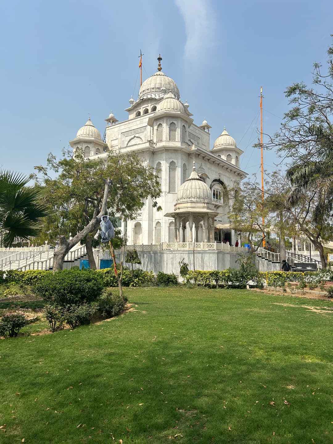 Gurdwara Bangla Sahib exterior with domes and Nishan Sahib flagpole.