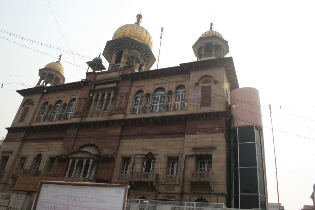 Gurudwara Sis Ganj Sahib exterior view showing golden domes.