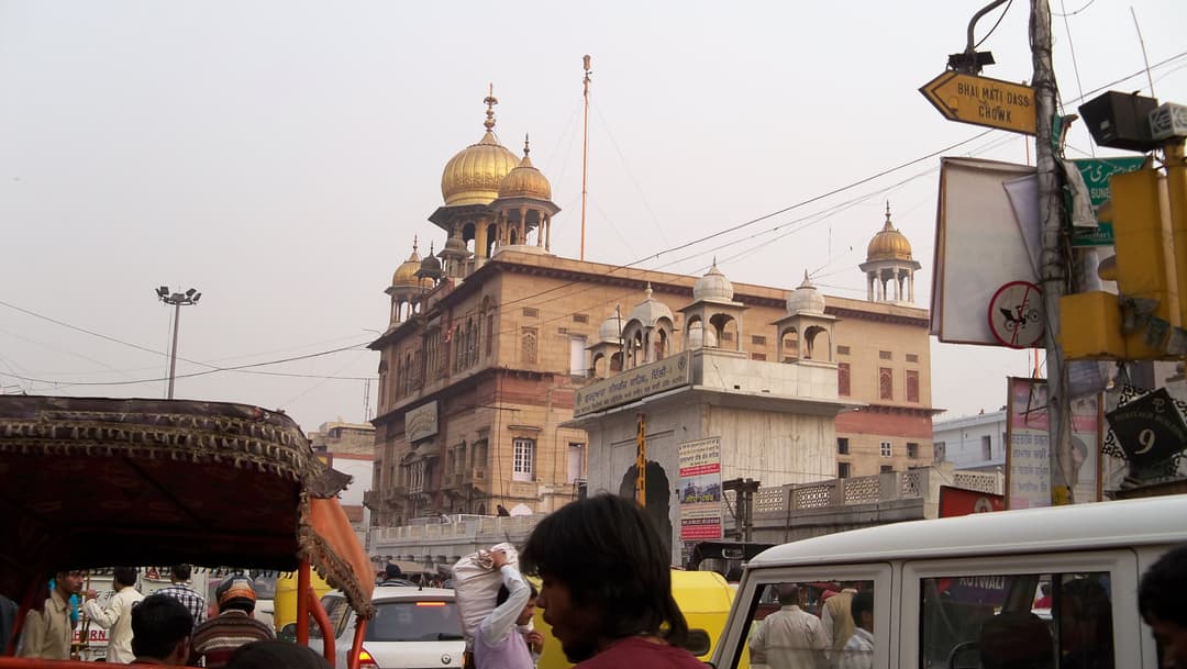 Gurudwara Sis Ganj Sahib exterior view with gold domes.
