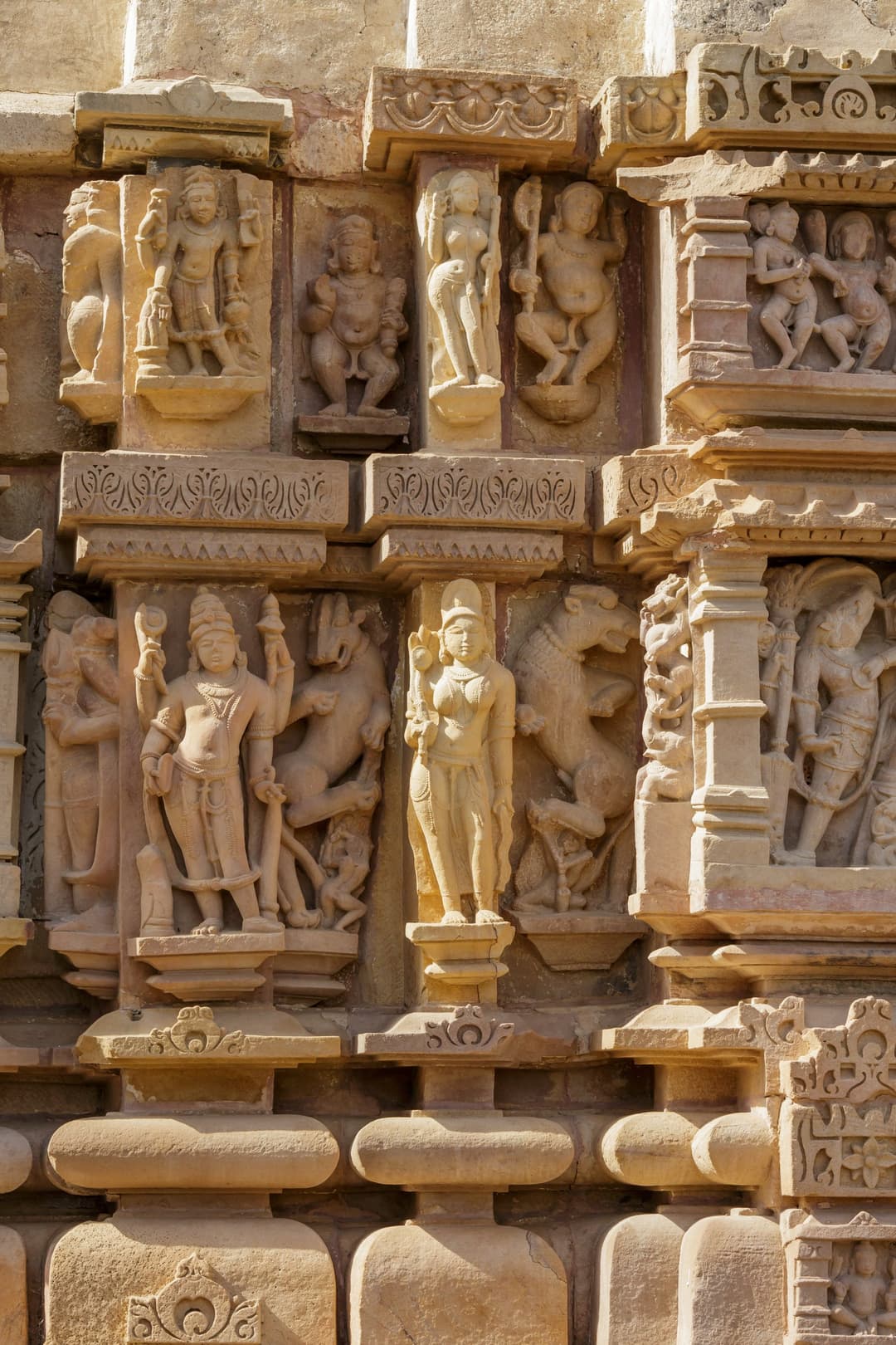 Detail of carved deities on the exterior wall of a Khajuraho temple