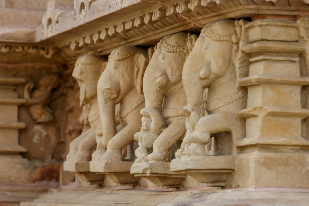 Carved elephant frieze on temple exterior plinth, Khajuraho