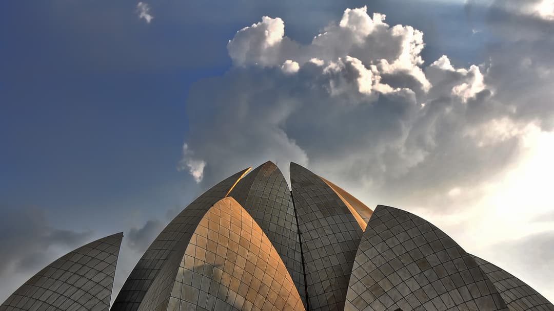 Low-angle view of the marble petals against a dramatic cloudy sky