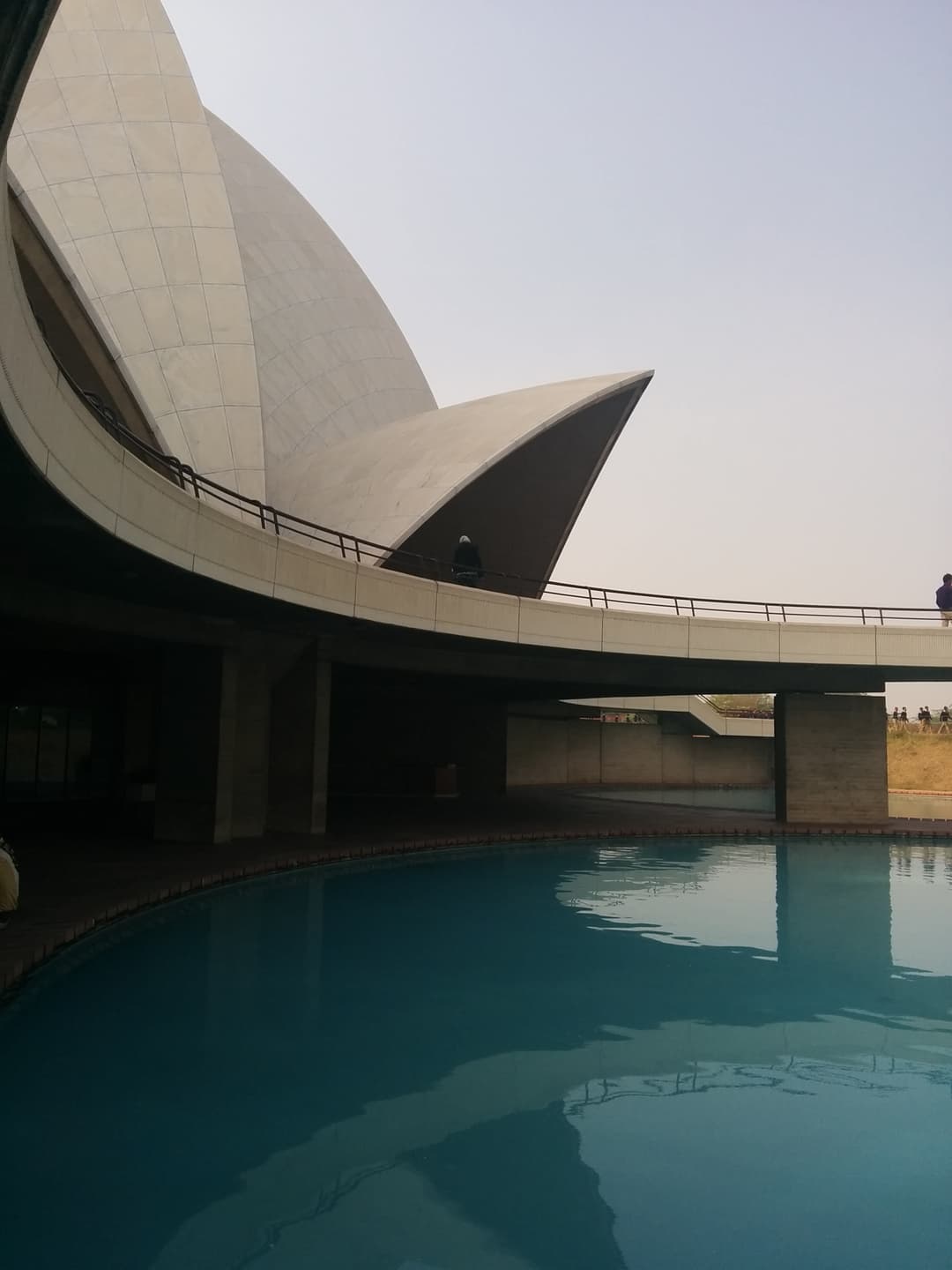 Reflecting pool and curved walkway at the base of the Lotus Temple.