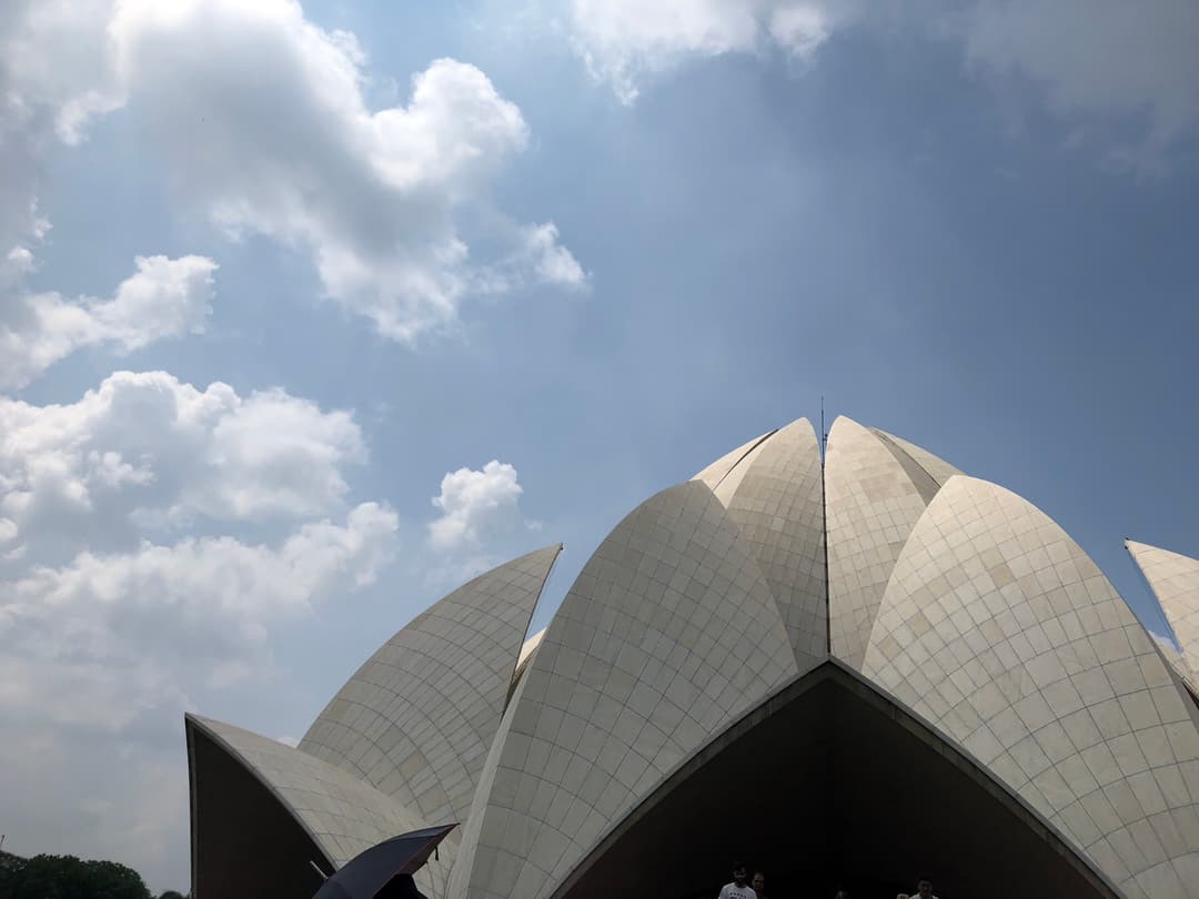 Low-angle view of the white marble petals against a blue sky