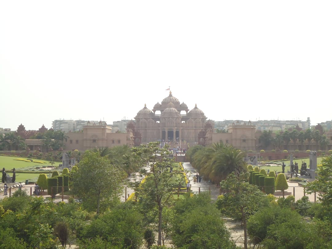 Distant wide-angle view of the Akshardham Mandir and surrounding gardens.