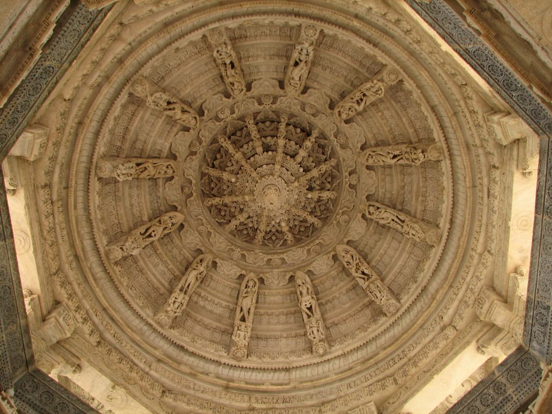 Intricately carved corbelled marble dome ceiling