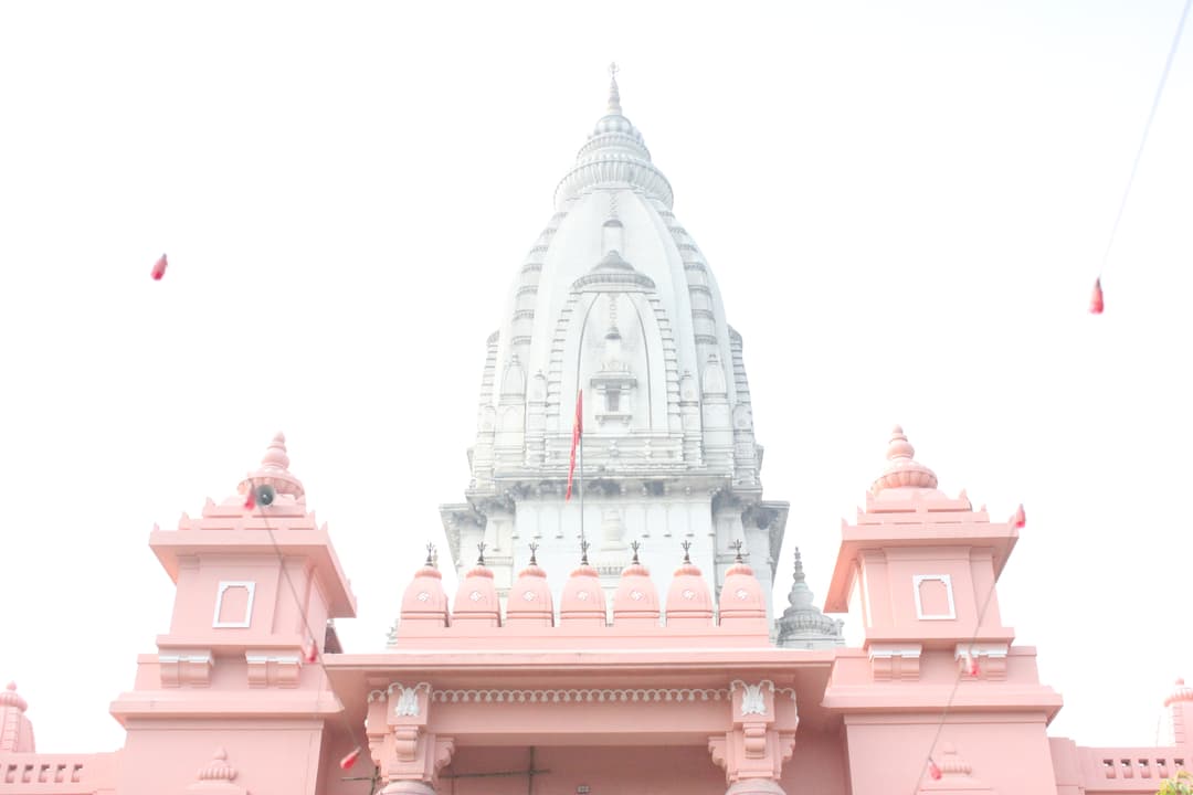 Central shikhara rising above the pink entrance gateway.