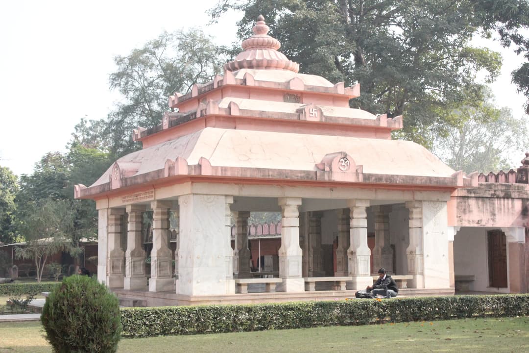 Open-air pillared pavilion set in the landscaped temple gardens.