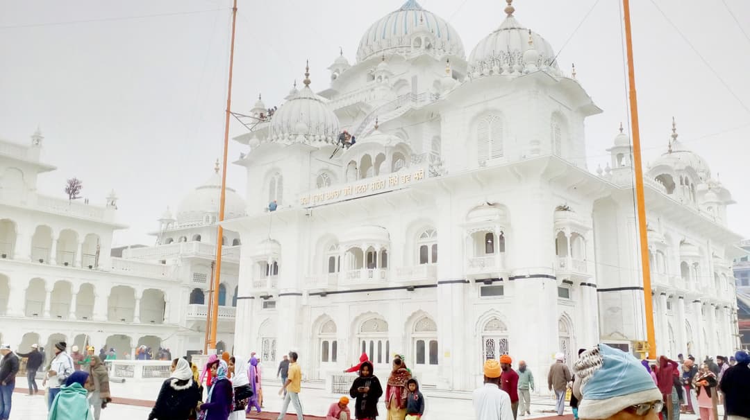 White marble facade and domes of Takhat Sri Patna Sahib with devotees