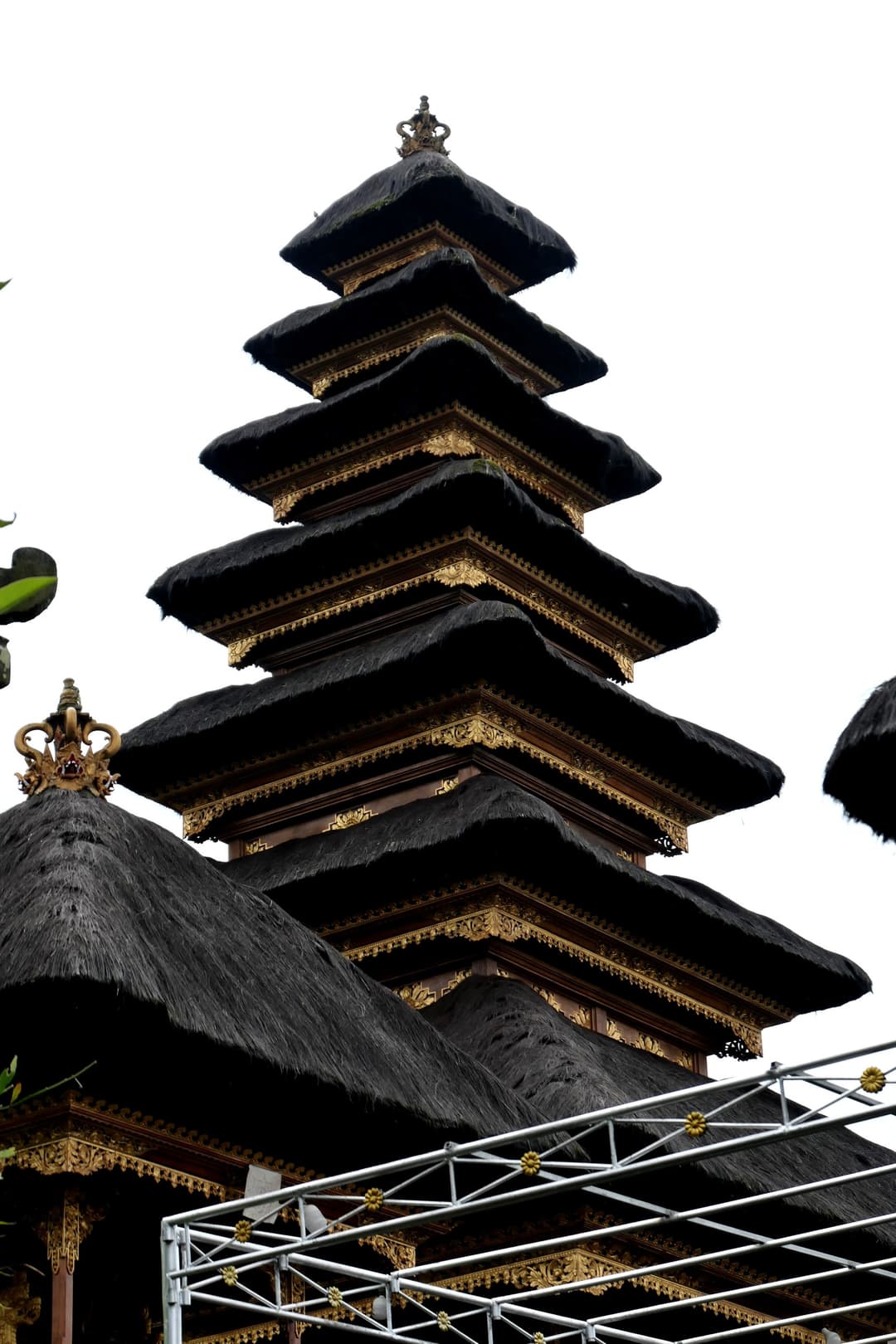 Besakih Temple: Multi-tiered meru tower with decorative gold trim.