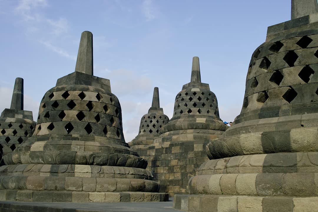 Perforated stone stupas on the upper circular terraces of Borobudur.